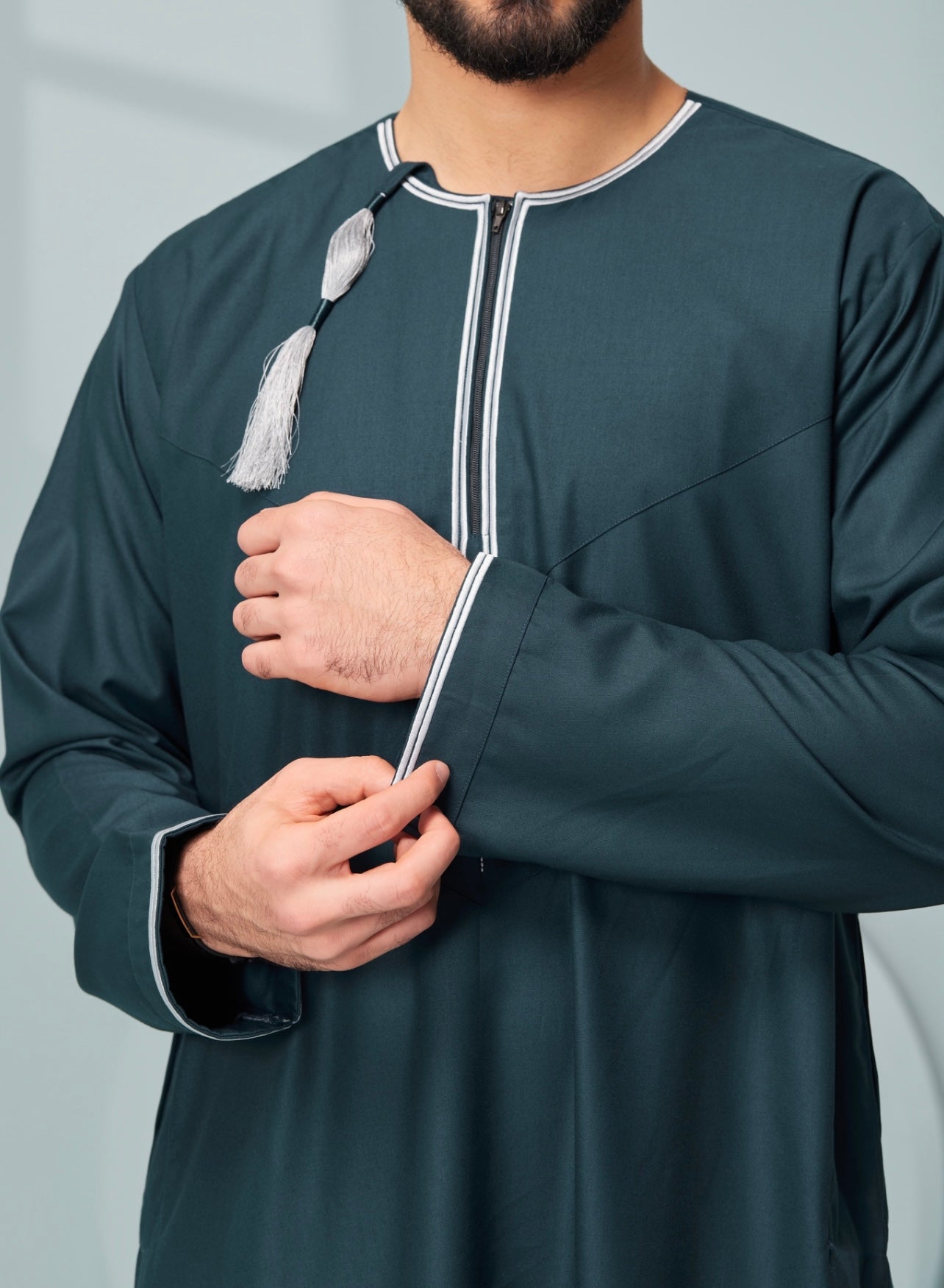 Men's Omani Style Thobe in Teal with Silver Tassel Omaar, our stylish mens embroidered Omani style thobe! thobeluxe authentic saudi thobes, premium thobes