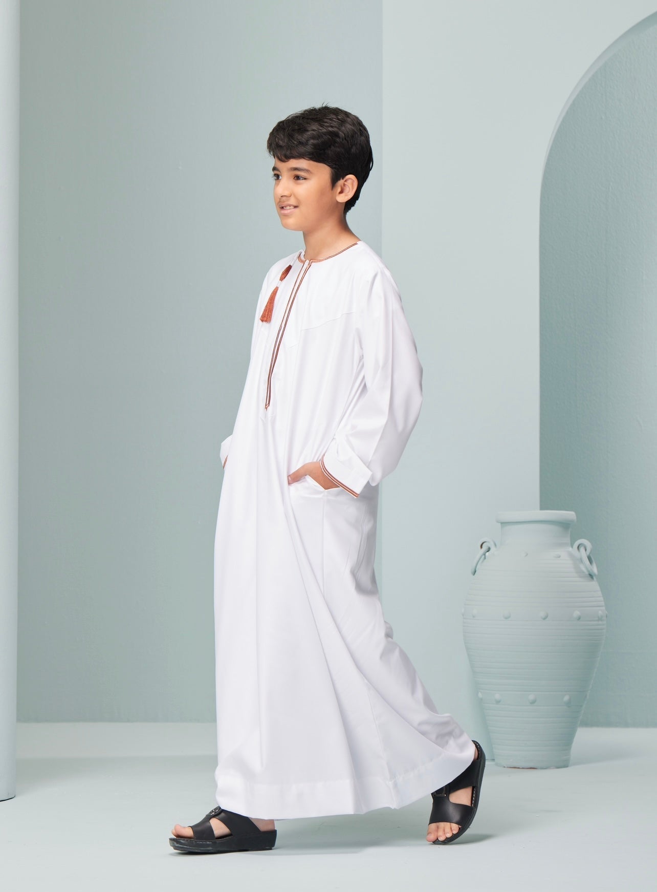 Kids Embroidered White Thobe with Copper Tassel Ages 3-13 Discover Kids Omaar thobe in white, Thobeluxe stylish embroidered Omani-style thobes for boys