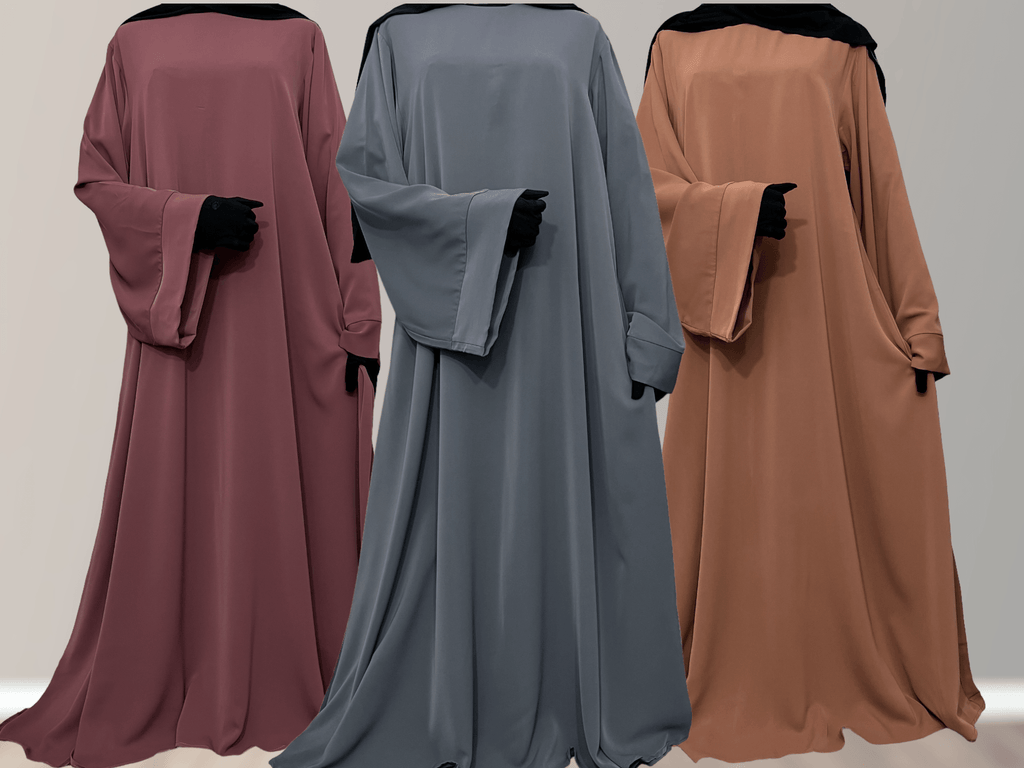 Three Nidha Abayas in different colors displayed in a row with their backs towards the camera, showcasing the wide sleeve and bell sleeve features.