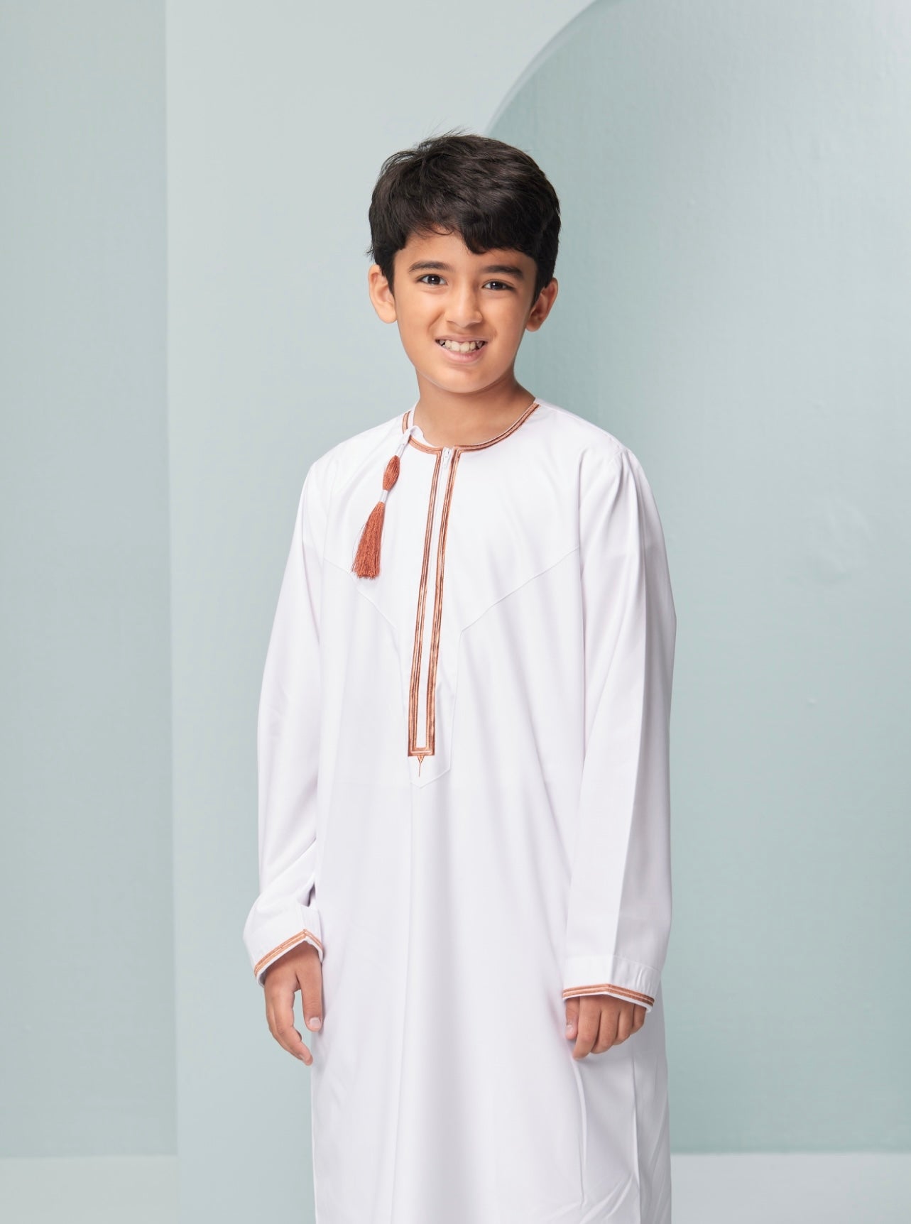 Kids Embroidered White Thobe with Copper Tassel Ages 3-13 Discover Kids Omaar thobe in white, Thobeluxe stylish embroidered Omani-style thobes for boys