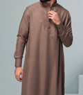 man wearing brown collard thobe