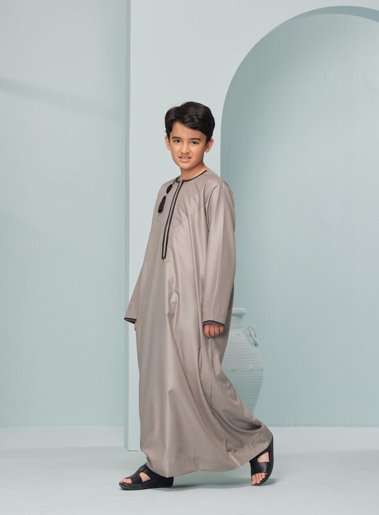 Kids Embroidered Beige Thobe with Black Tassel Ages 3-13 Kids Omaar thobe in Beige, Thobeluxe stylish embroidered Omani-style thobes for boys saudi thobes