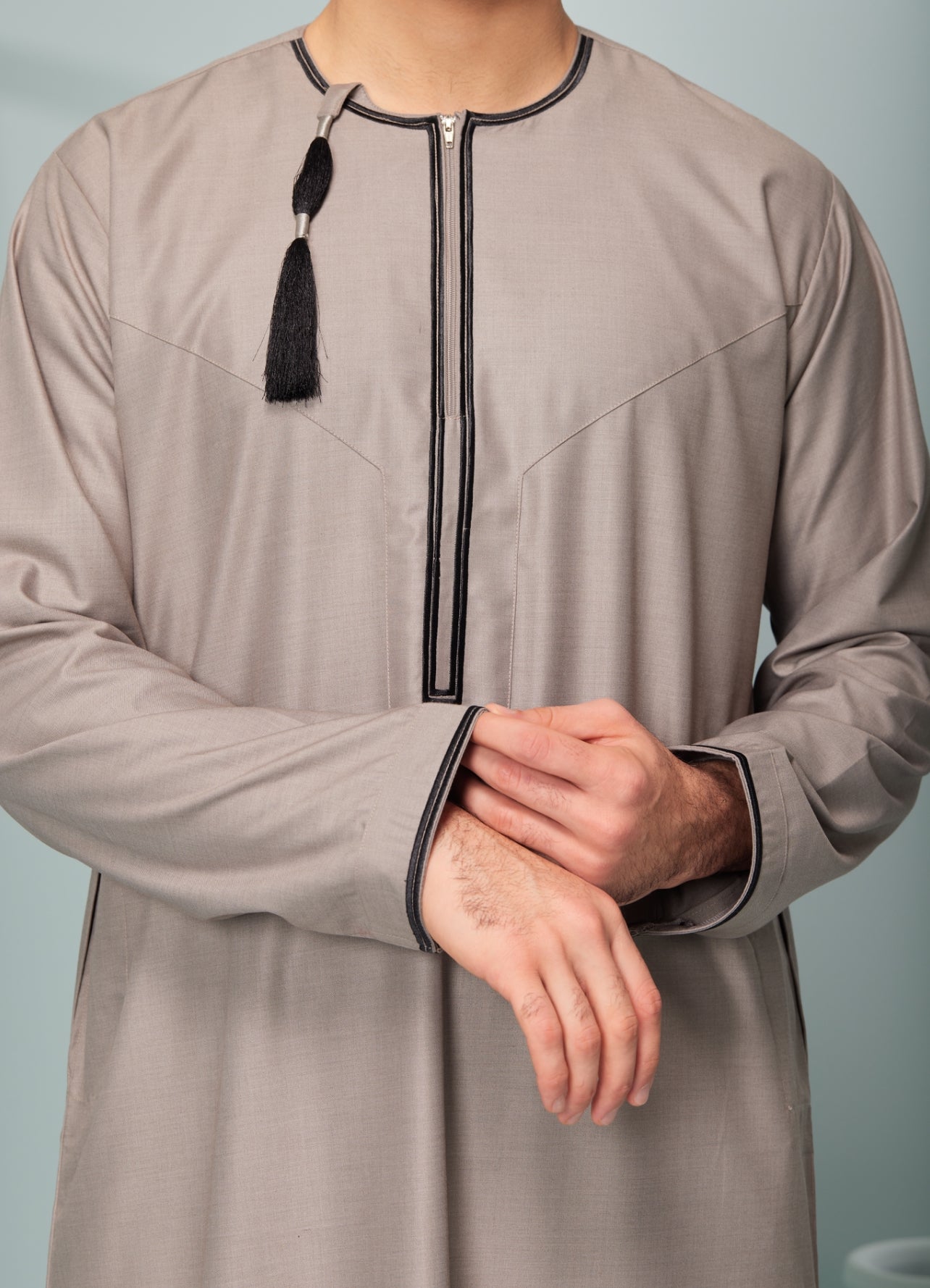 Men's Omani Style Thobe in Beige with Black Tassel, premium thobes, Omaar clothing thobeluxe stylish mens embroidered Omani style thobe