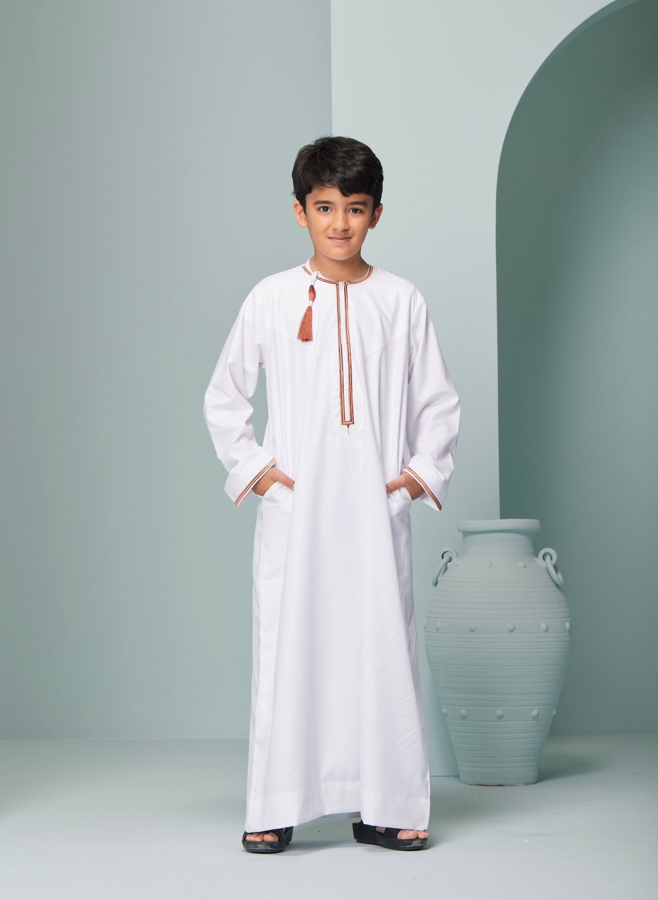 Kids Embroidered White Thobe with Copper Tassel Ages 3-13 Discover Kids Omaar thobe in white, Thobeluxe stylish embroidered Omani-style thobes for boys