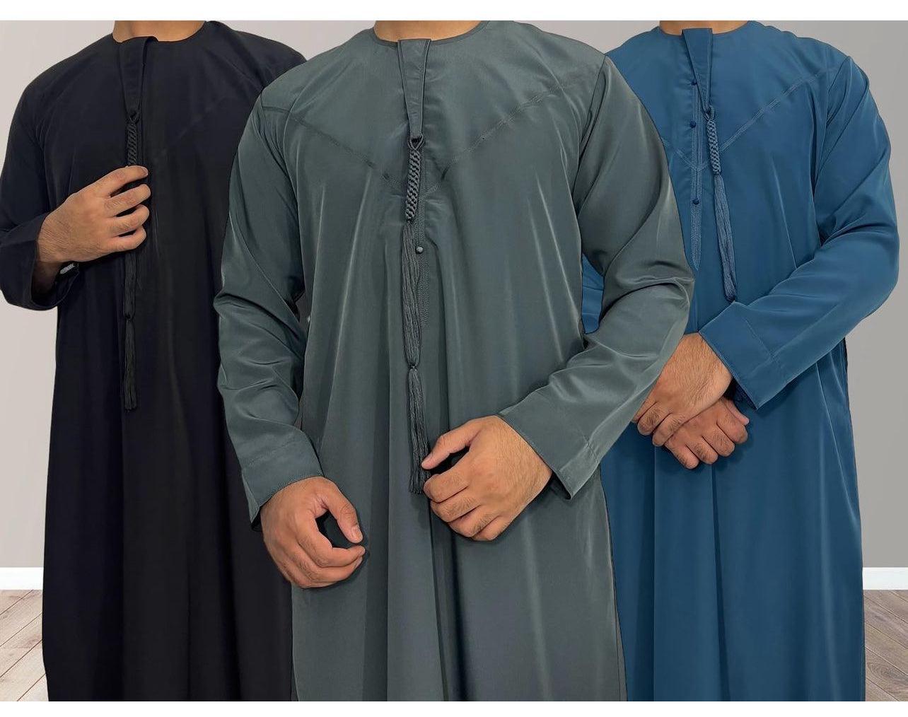 Three men's traditional Emirati thobes in, black, and green and blue colours, featuring a non-shiny Omani tassel and chest zip opening. 