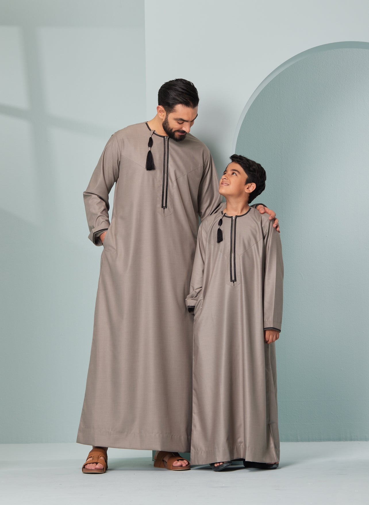 Kids Embroidered Beige Thobe with Black Tassel Ages 3-13 Kids Omaar thobe in Beige, Thobeluxe stylish embroidered Omani-style thobes for boys saudi thobes