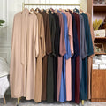 Row of long-sleeve shirts in various colors hanging on a rack.