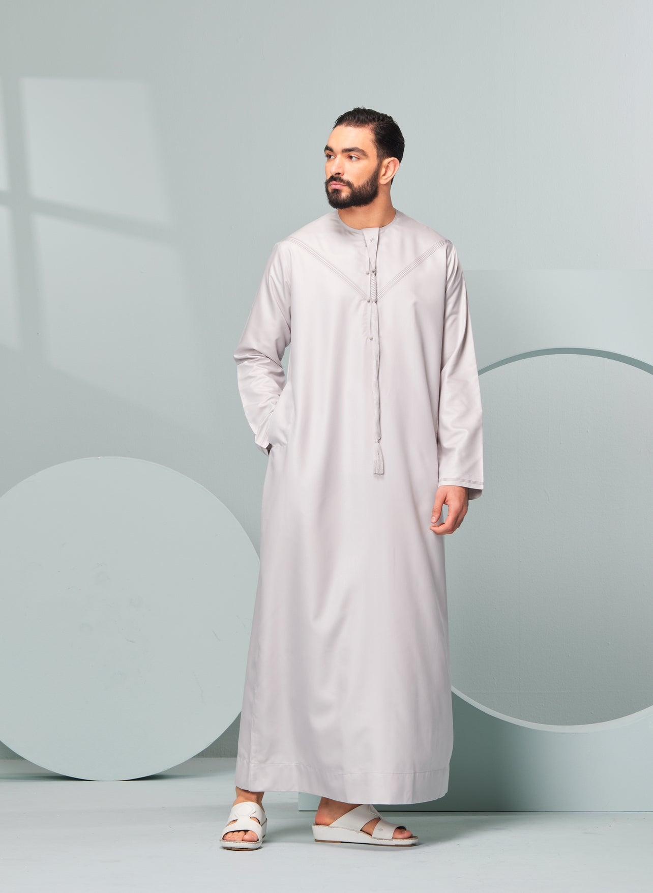 Men's Premium Emaar Thobe in Stone Beige with Tassel, Emaar, our luxurious Emirati style thobe made in the UAE. Authentic Saudi Thobes by Thobeluxe