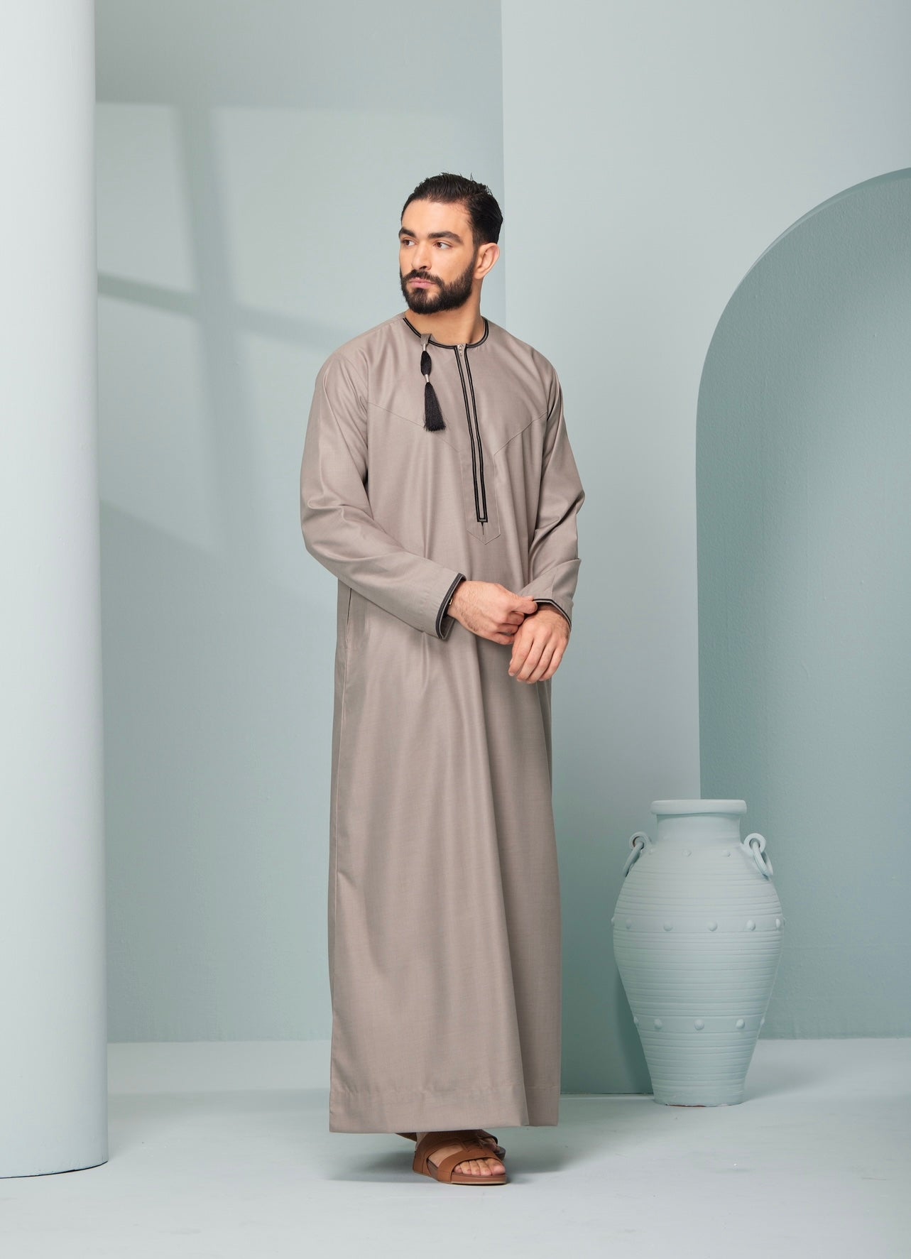 Men's Omani Style Thobe in Beige with Black Tassel, premium thobes, Omaar clothing thobeluxe stylish mens embroidered Omani style thobe