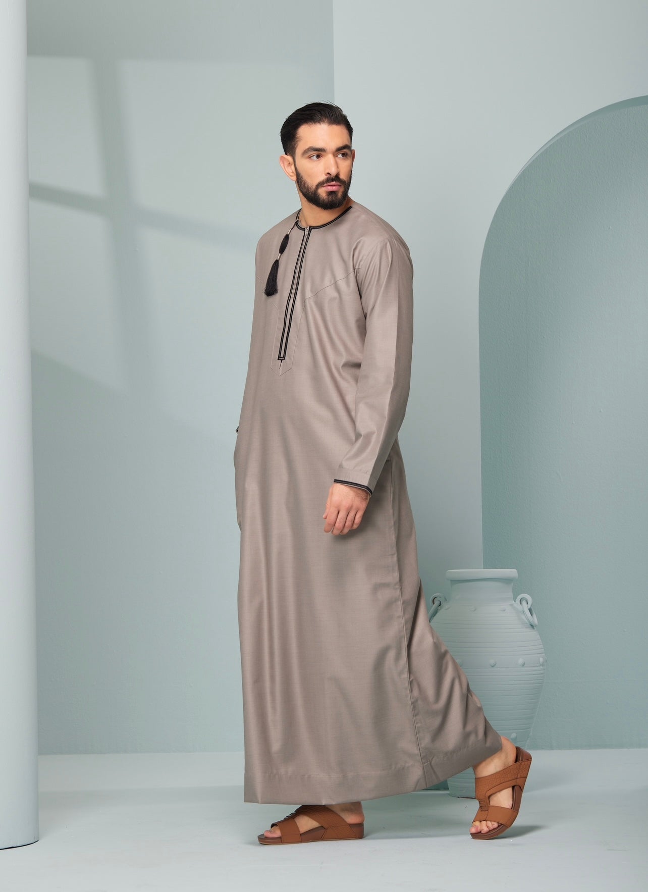 Men's Omani Style Thobe in Beige with Black Tassel, premium thobes, Omaar clothing thobeluxe stylish mens embroidered Omani style thobe