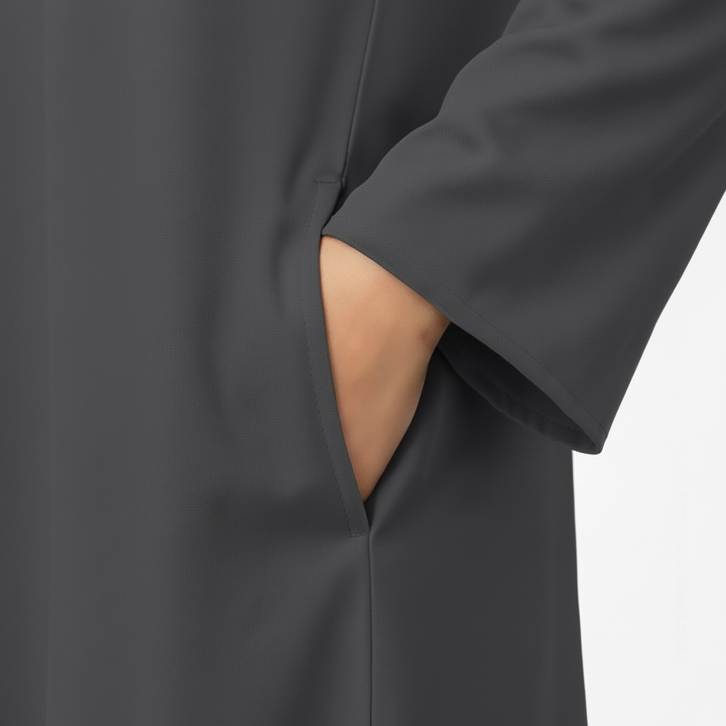 dark gray abaya with a pocket on a light gray background