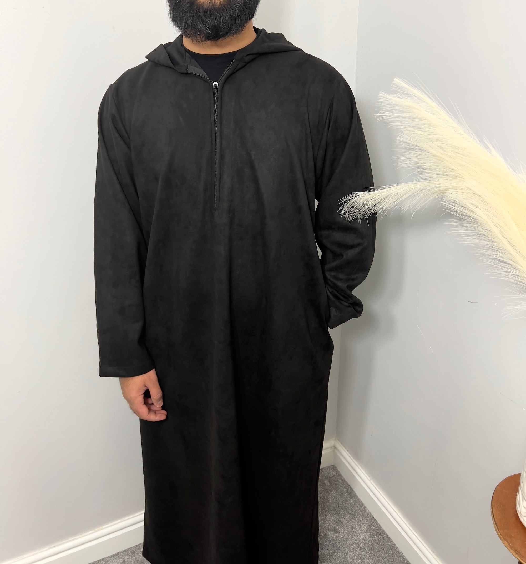 hooded and long sleeve thobe in suede material in black colour worn by man