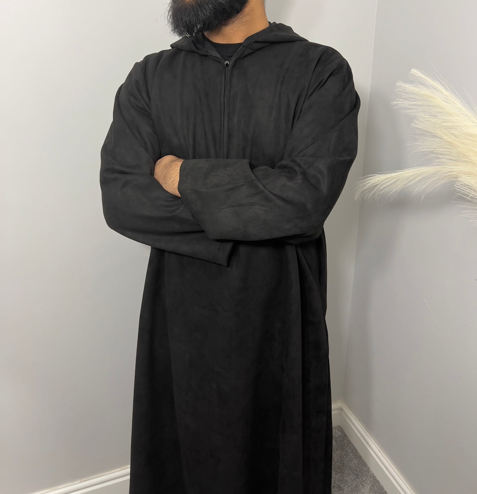 hooded and long sleeve thobe in suede material in black colour worn by man
